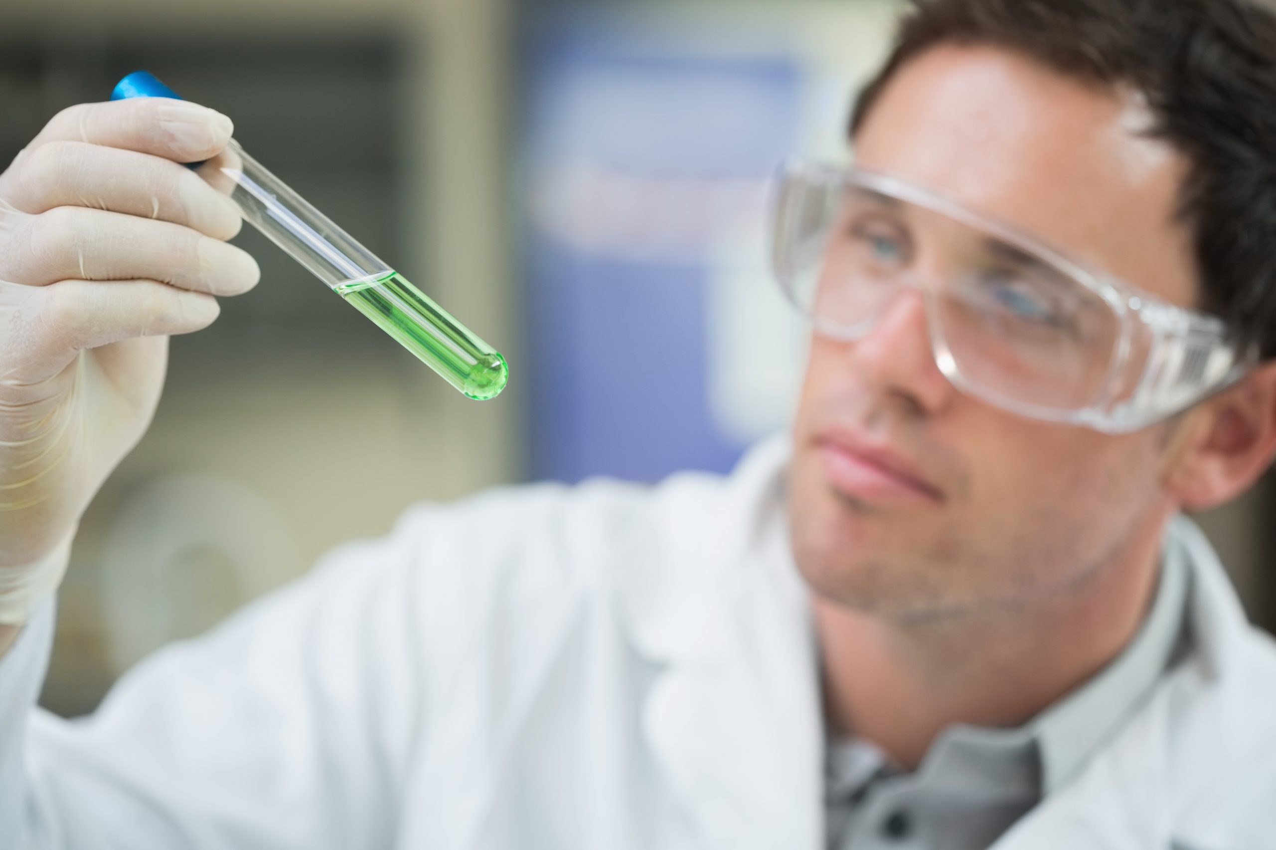 scientist-analyzing-green-solution-test-tube-laboratory